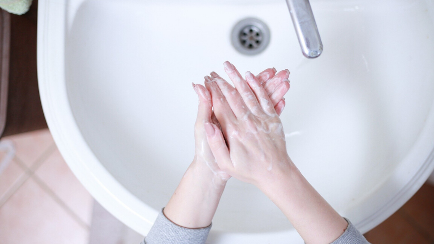 washing hands over sink